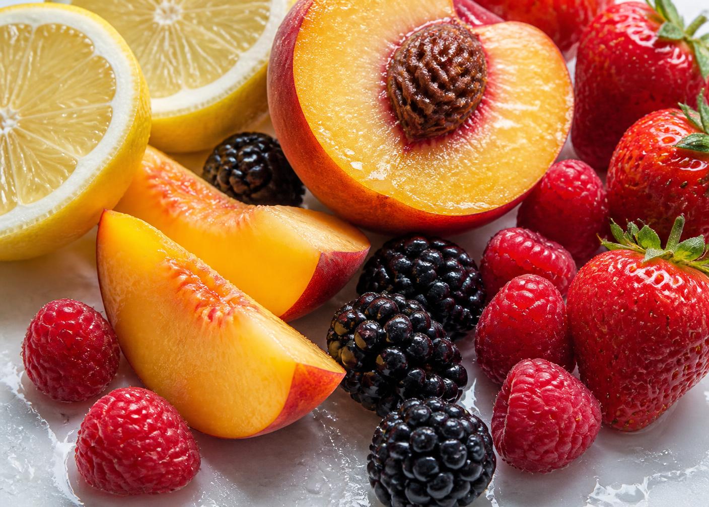 Fresh lemon, peach slices, raspberries, blackberries and strawberries